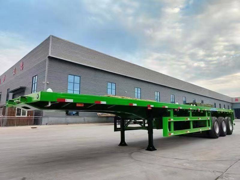 Green three-axle flatbed semi-trailer